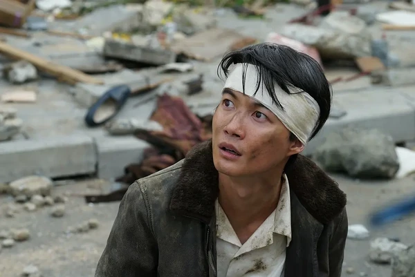 Man with headband looking up in ruins in Godzilla-1.0